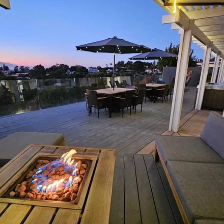 Fire pit and outdoor dining deck at dusk