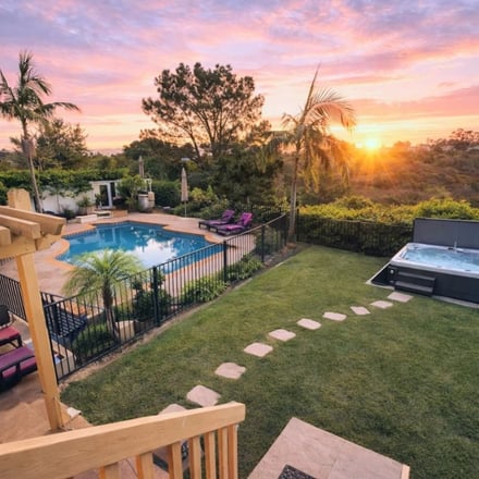 Pool, hot tub, and garden at golden hour